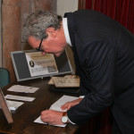 High Commissioner signs register